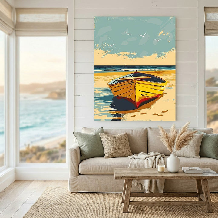 Wadi Home coastal boat scene framed wall art with a yellow boat on a sandy beach, displayed above a modern living room sofa.