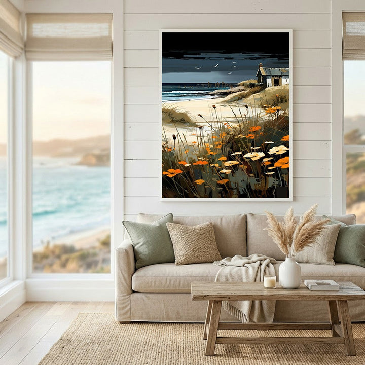 Wadi Home coastal landscape wall art print featuring a moody sky, orange wildflowers, and a cottage above a sofa.