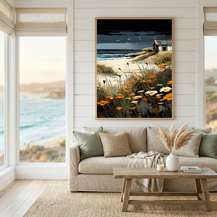 Wadi Home coastal landscape wall art print featuring orange wildflowers and a seaside cottage in a modern living room