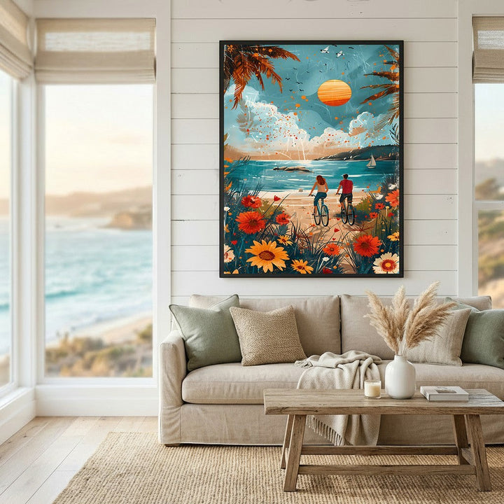 Wadi Home coastal landscape wall art print featuring a couple cycling by a flower-lined beach at sunset in a living room