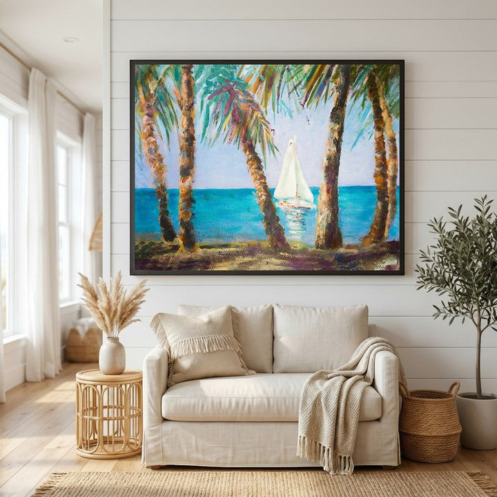 Wadi Home coastal sailboat landscape wall art in a black frame hanging above a beige sofa in a bright living room.