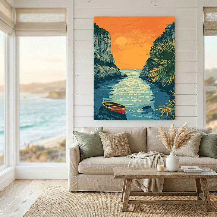 Wadi Home coastal landscape wall art print featuring a sunset over a cove with a rowboat, displayed above a sofa.