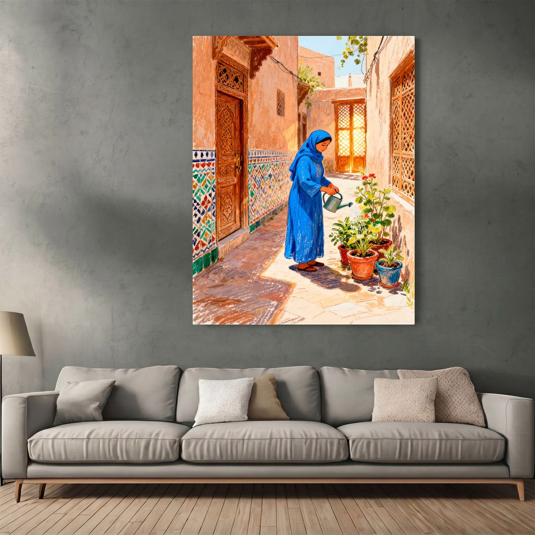 Wadi Home framed wall art featuring a woman in a blue dress watering plants in a traditional sunlit courtyard.