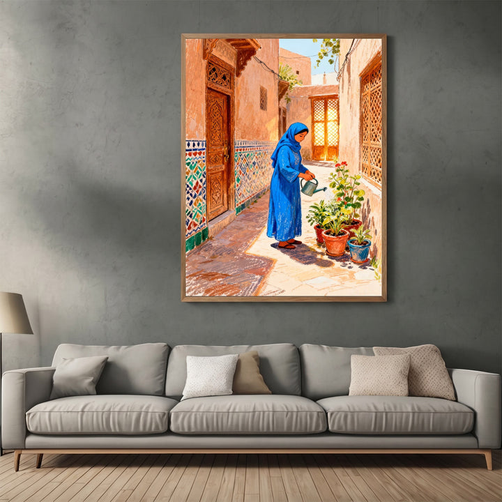 Wadi Home framed wall art featuring a woman in a blue dress watering plants in a traditional sunlit courtyard.