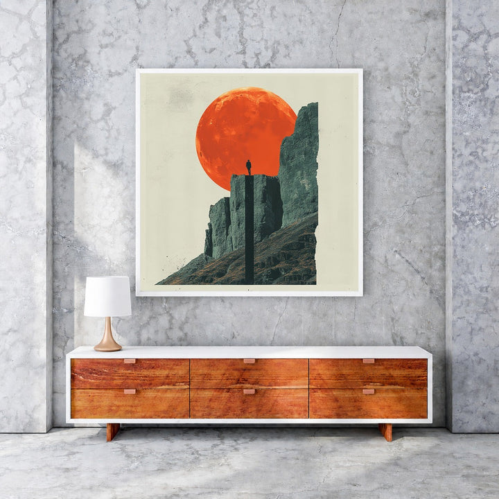 Wadi Home 'Solitude Under The Crimson Moon' art print: lone figure on mountain peak under large orange moon.