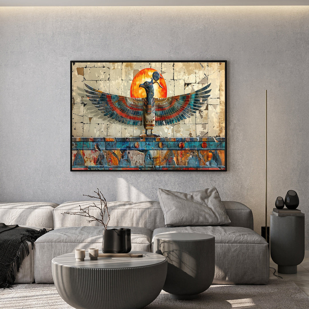 Wadi Home ancient Egyptian style wall art featuring a winged deity and glowing sun above a modern grey living room sofa.