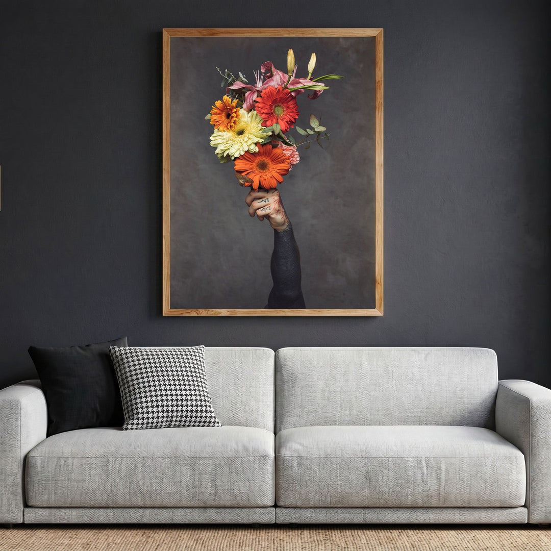 Wadi Home framed wall art of a tattooed hand holding a vibrant floral bouquet against a dark grey background.