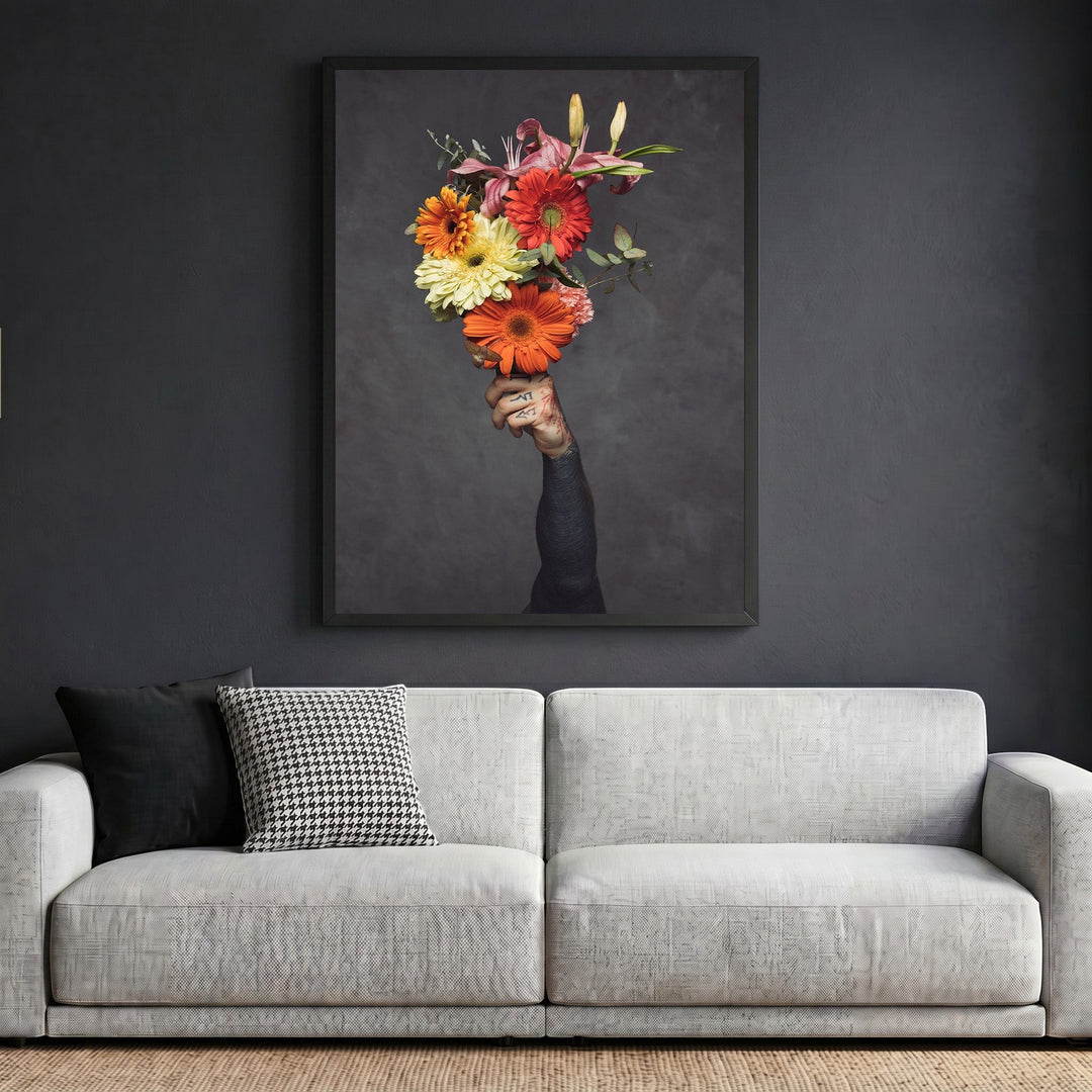 Wadi Home framed wall art featuring a tattooed hand holding a vibrant floral bouquet against a dark grey background.