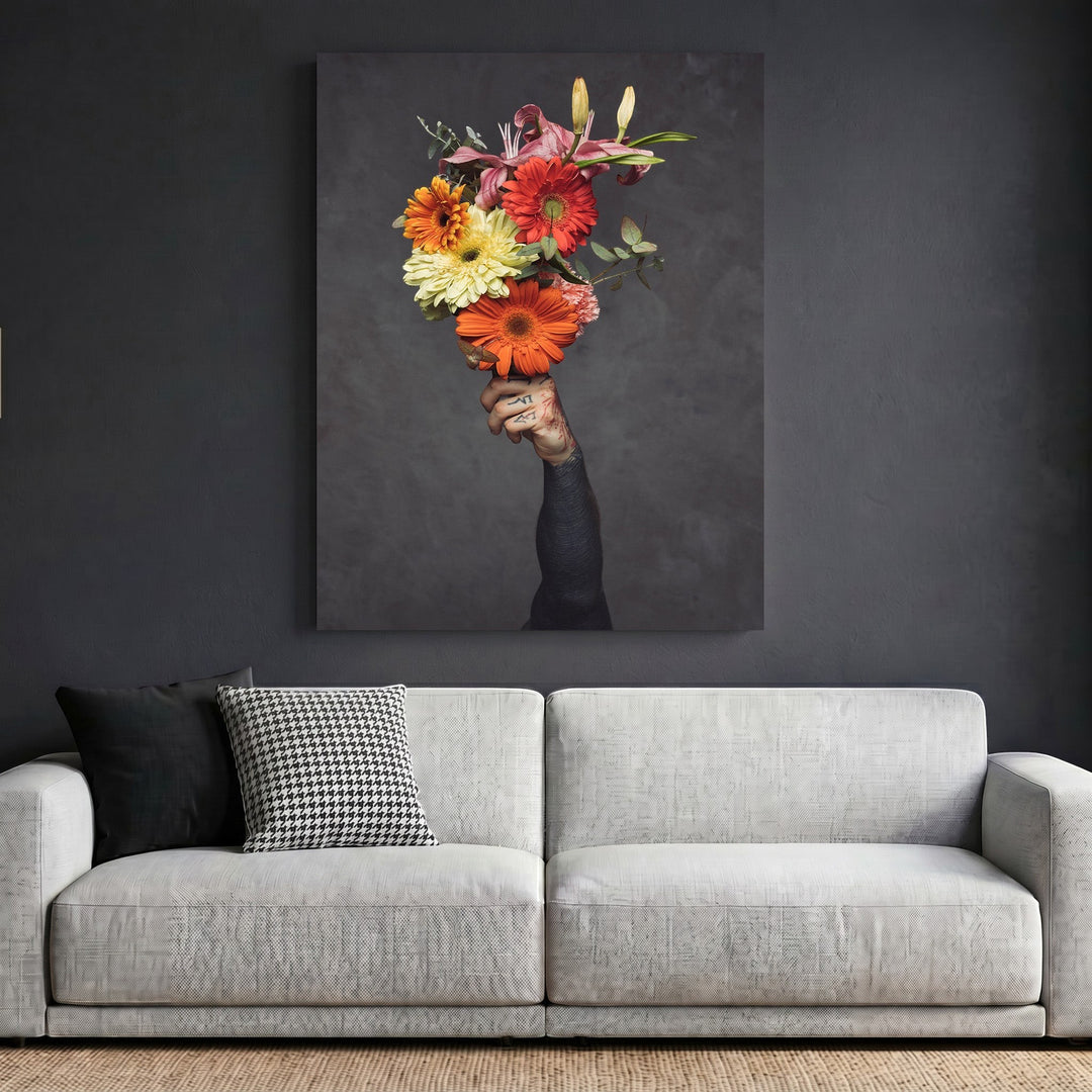 Wadi Home framed wall art featuring a tattooed hand holding a vibrant floral bouquet against a dark grey background.