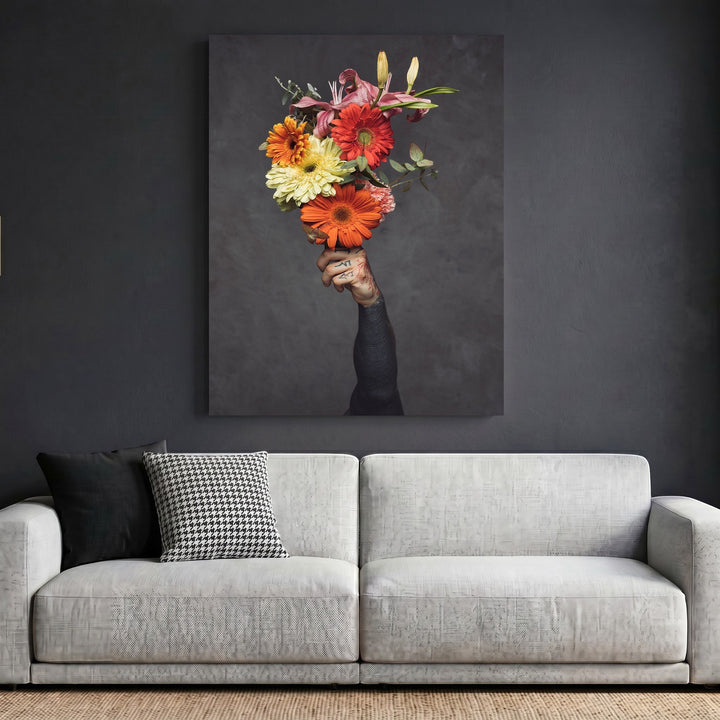 Wadi Home framed wall art featuring a tattooed hand holding a vibrant floral bouquet against a dark grey background.
