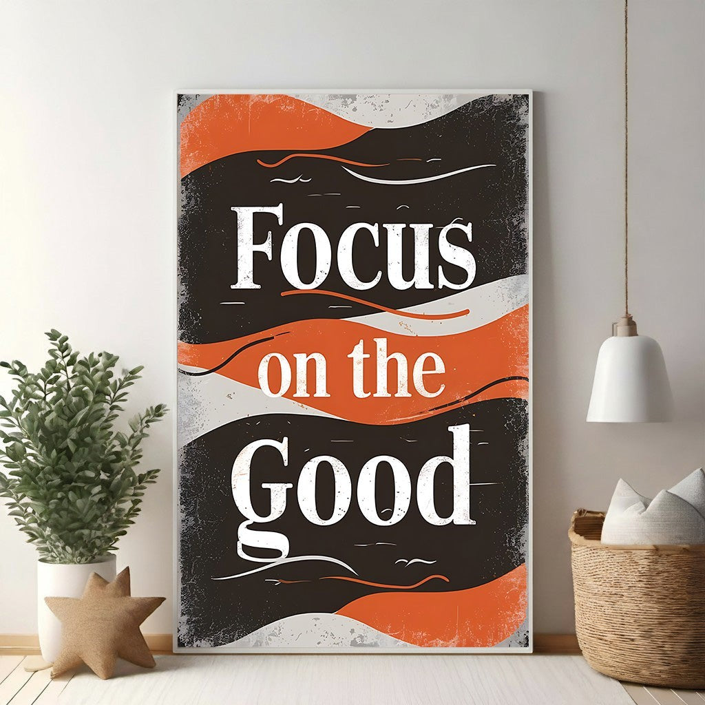 Wadi Home motivational wall art with bold white typography reading "Focus on the Good" on a distressed black and orange background.