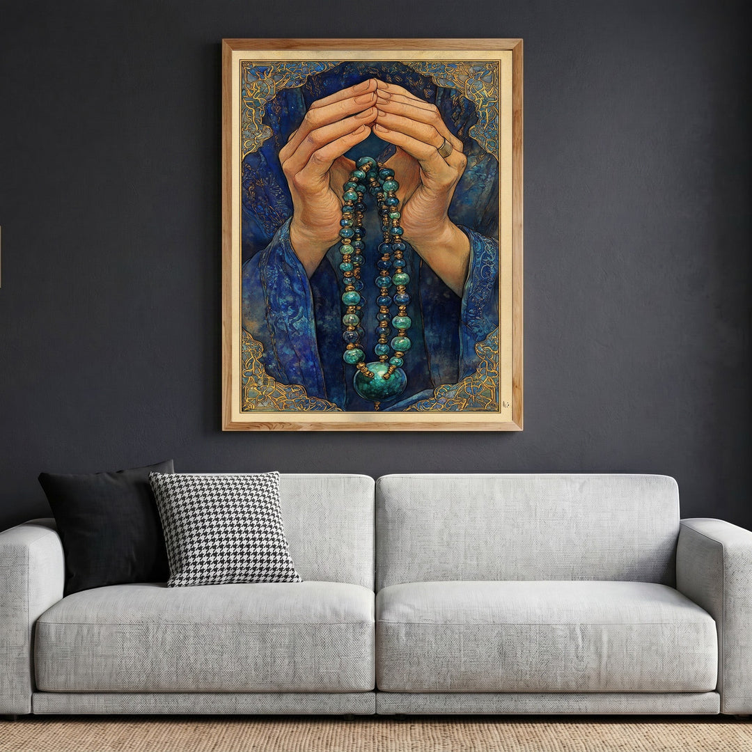 Wadi Home framed wall art featuring prayerful hands with blue beads and gold accents hanging above a grey sofa.