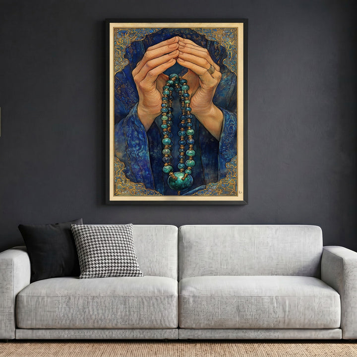 Wadi Home framed wall art print featuring hands in prayer with blue and gold beaded prayer beads on a dark wall.