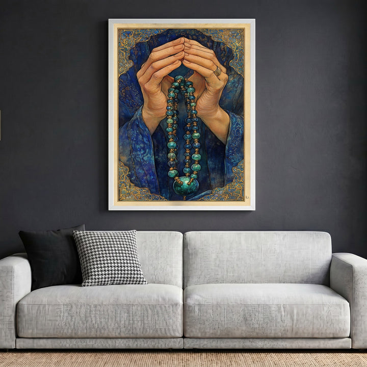 Wadi Home framed wall art print featuring hands in prayer with blue and gold beaded jewelry on a dark grey wall.