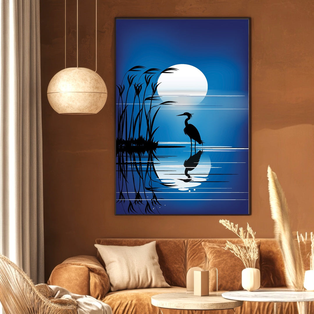 Wadi Home heron silhouette wall art print featuring a blue moonlit scene with reeds, displayed in a modern living room.