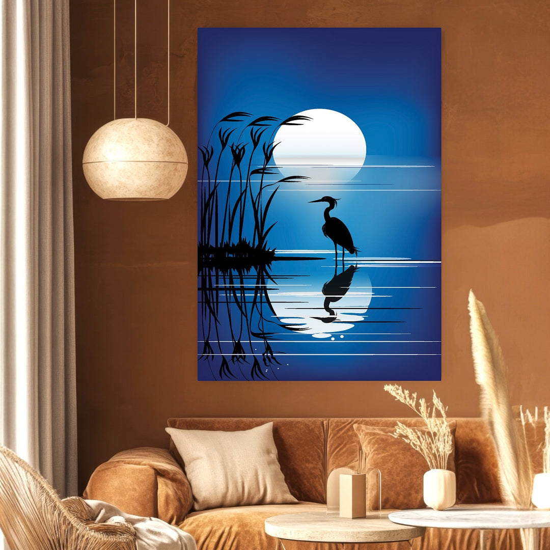 Wadi Home heron silhouette wall art print featuring a full moon and reeds in deep blue tones above a brown sofa.