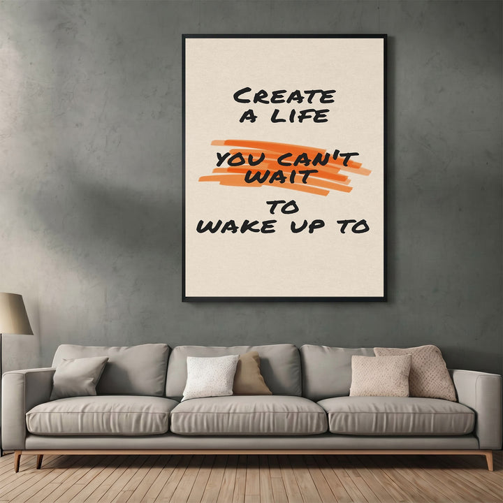 Wadi Home motivational wall art poster with black typography and orange brushstroke detail hanging above a grey sofa.