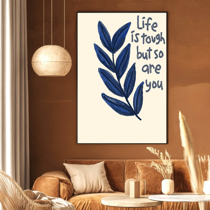 Wadi Home inspirational quote wall art with navy blue botanical leaf motif on cream background in a modern living room