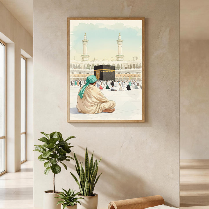 Wadi Home Islamic pilgrimage artwork depicting the Kaaba and pilgrims in a watercolor style. A man in a teal turban sits facing the Kaaba.