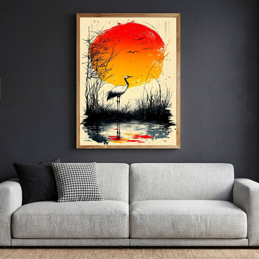 Wadi Home Japanese inspired crane wall art print featuring a red sun and marsh landscape in a wooden frame above a sofa.