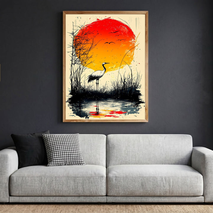 Wadi Home Japanese inspired crane wall art print featuring a red sun and marsh landscape in a wooden frame above a sofa.
