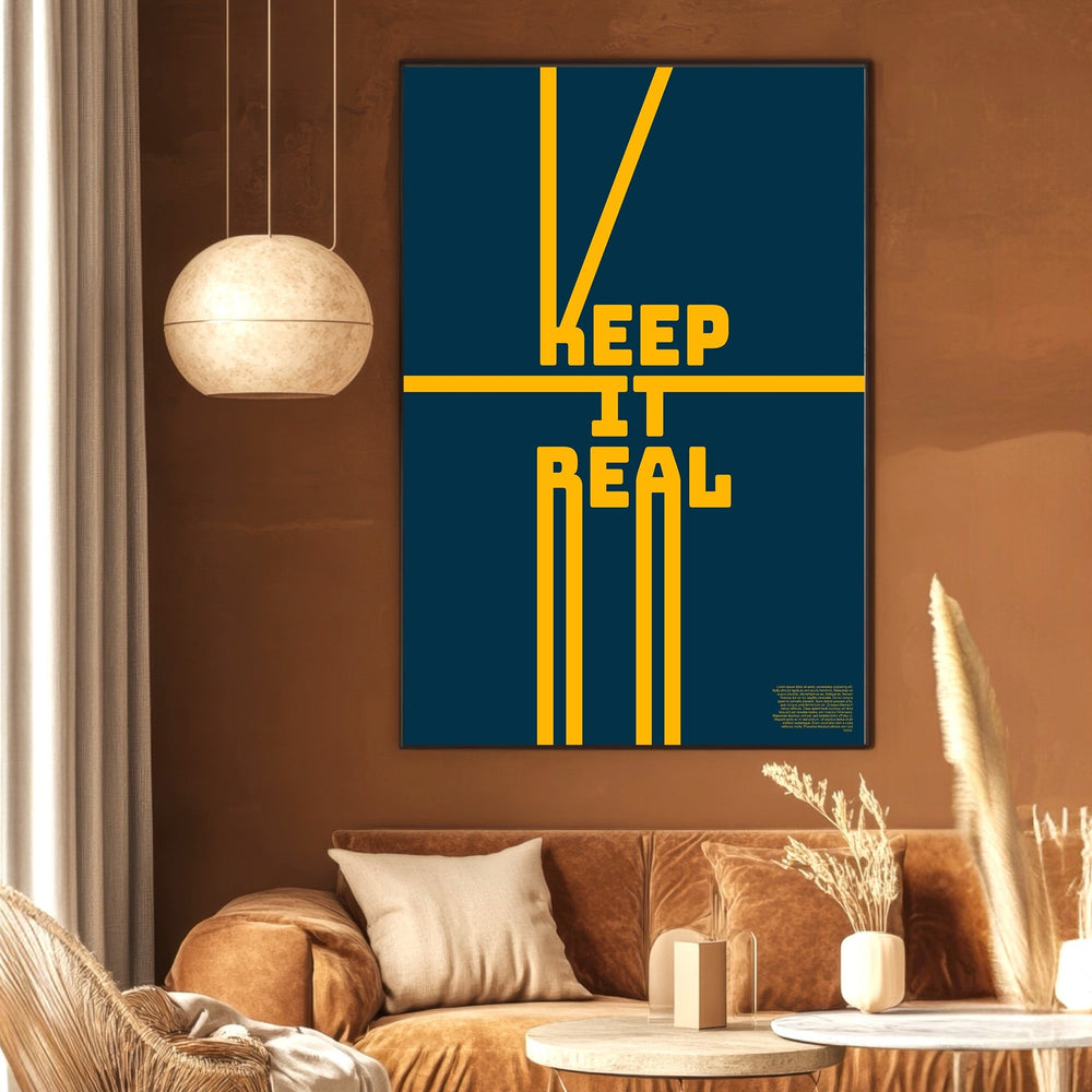 Wadi Home Keep It Real typography wall art poster with yellow text on a navy blue background in a modern living room.