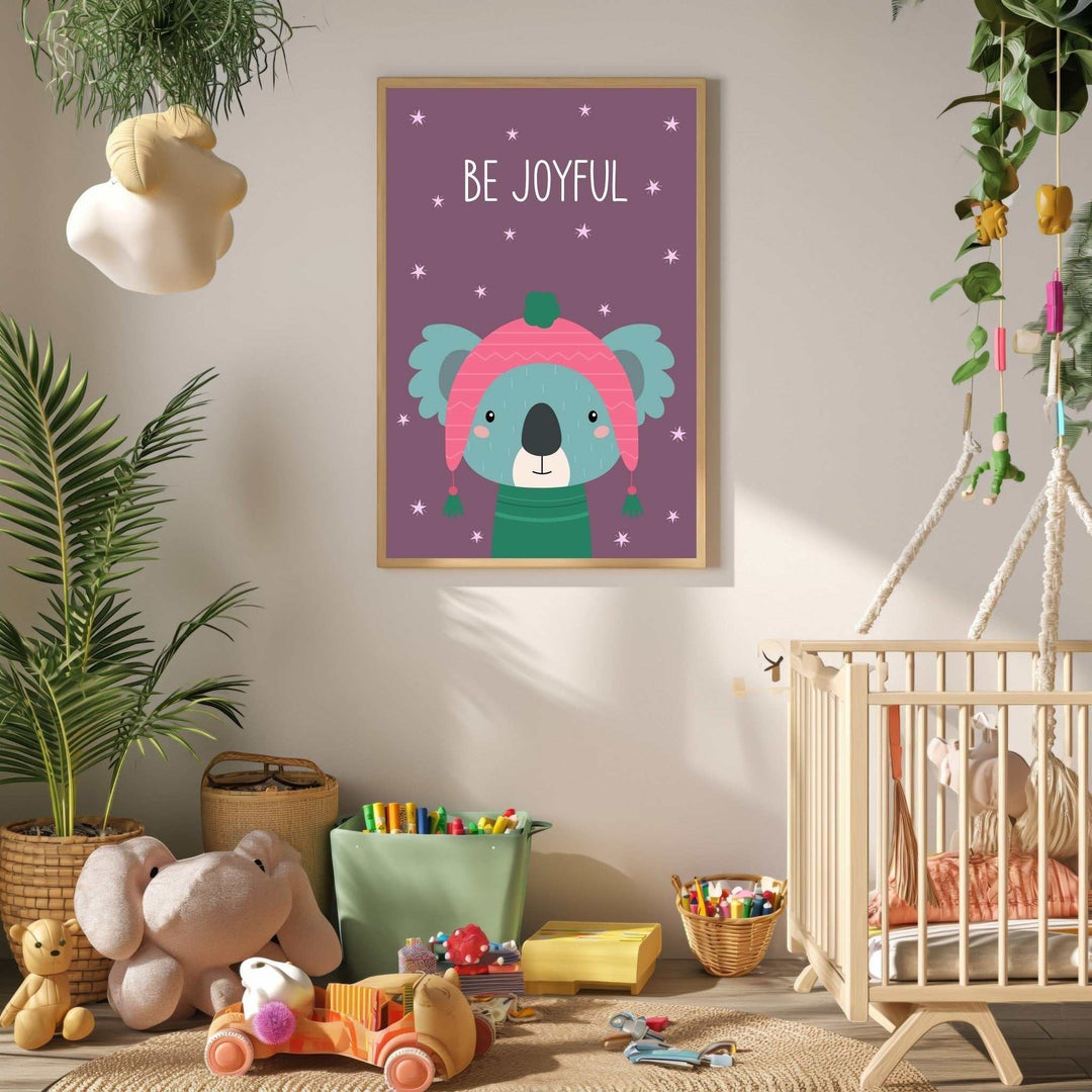 Wadi Home 'Be Joyful' koala nursery art with pink hat and green sweater on purple background with stars.
