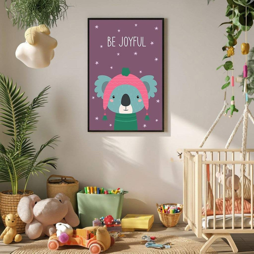 Wadi Home 'Be Joyful' koala nursery art with pink hat and green sweater on purple background with stars.