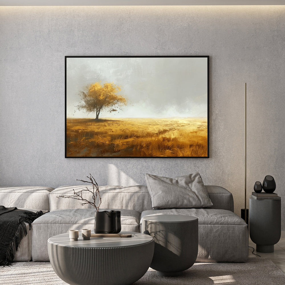 Wadi Home landscape field tree framed wall art with golden hues hanging above a grey sofa in a modern living room.