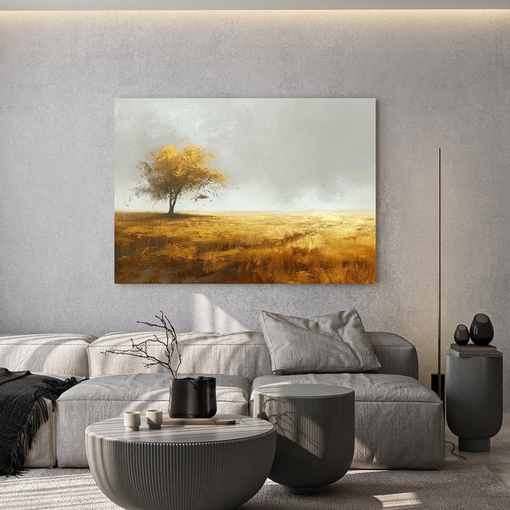 Wadi Home landscape wall art featuring a golden tree in a field, displayed above a grey sofa in a modern living room.