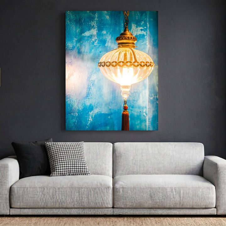 Wadi Home decorative wall art print featuring a glowing lantern against a textured blue background above a sofa.