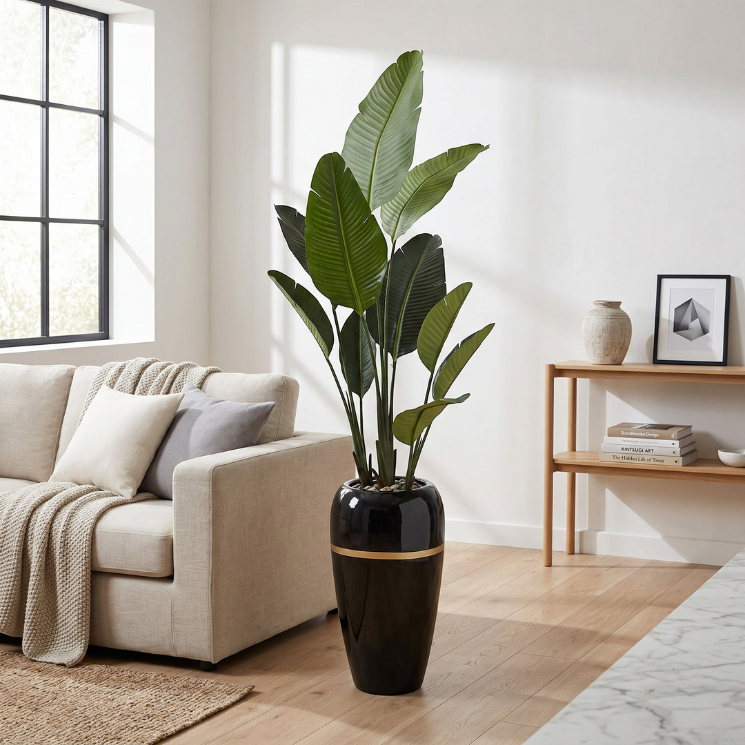 Wadi Home Large Bird of Paradise artificial plant with lush green leaves in a tall black pot with gold band.
