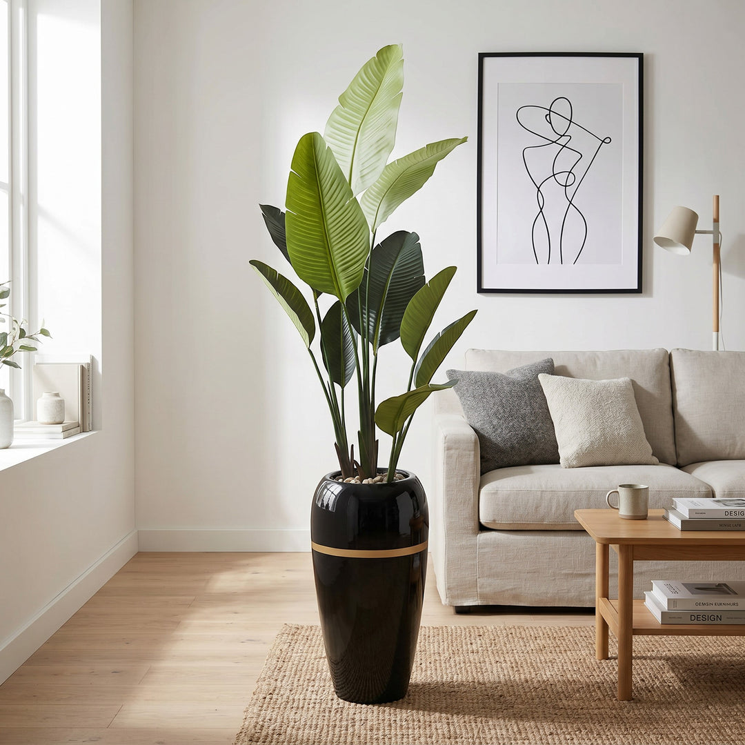 Wadi Home Large Bird of Paradise artificial plant with lush green leaves in a tall black pot with gold band.
