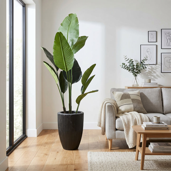 Wadi Home Large Bird of Paradise artificial plant with lush green leaves in a textured black planter.