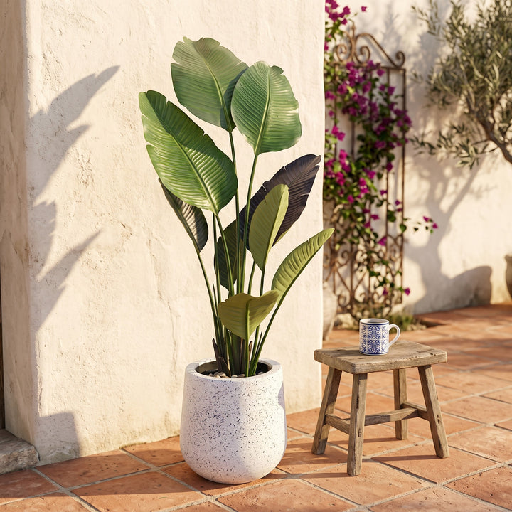Wadi Home Large Bird of Paradise artificial plant with lush green leaves in a speckled white pot.