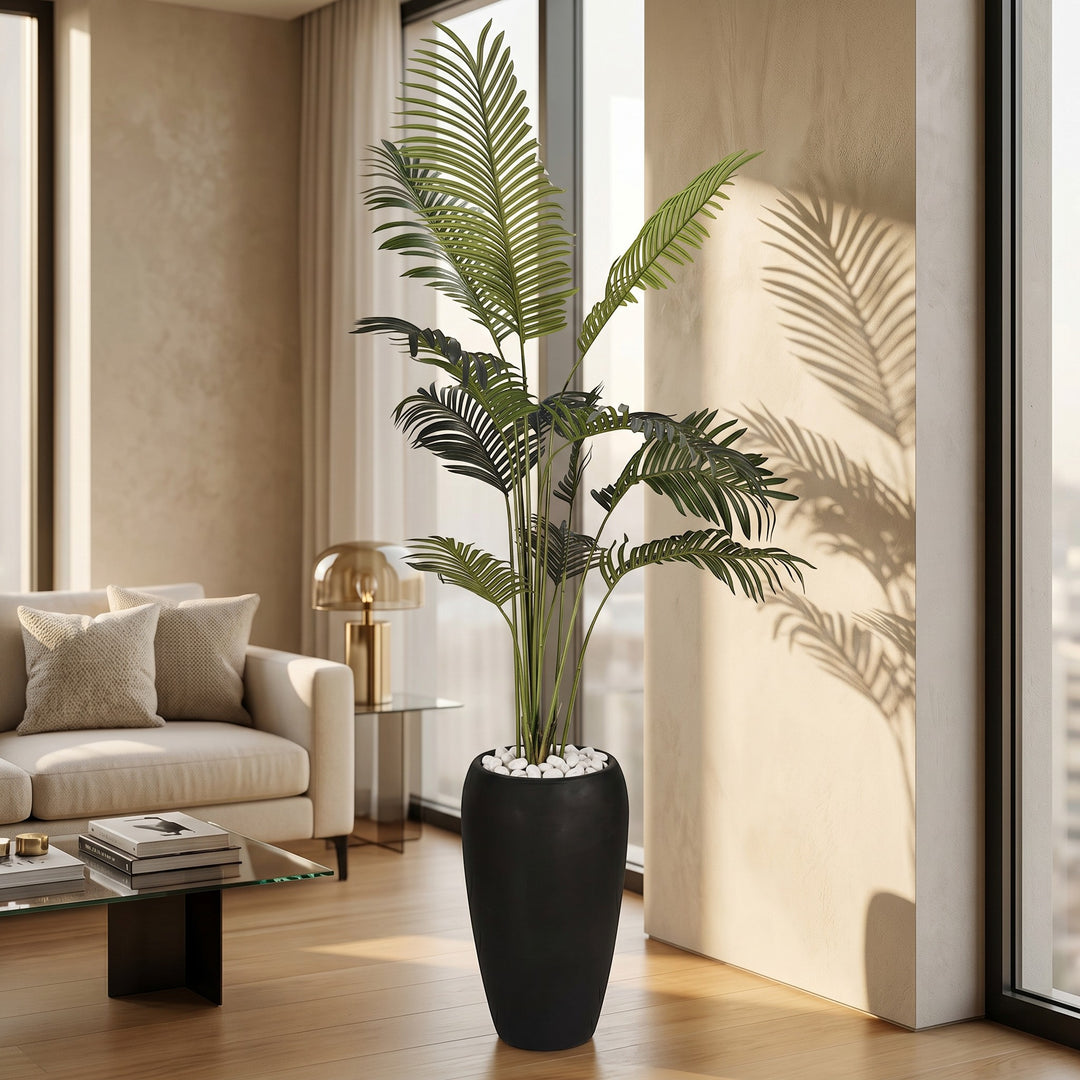 Wadi Home Large Faux Areca Palm Plant in tall black planter with white river stones. Lush green fronds.
