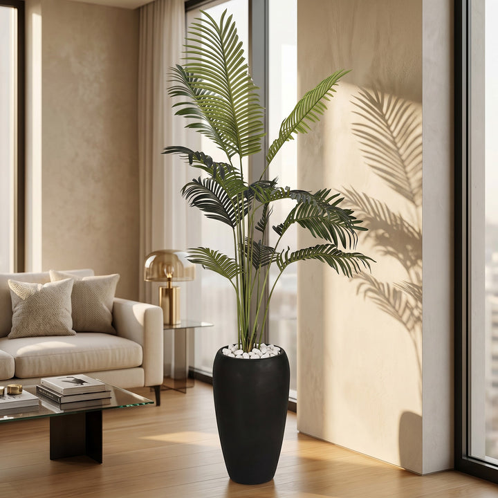 Wadi Home Large Faux Areca Palm Plant in tall black planter with white river stones. Lush green fronds.