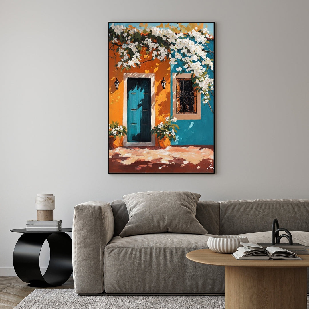 Wadi Home painting of a teal Mediterranean doorway with white flowers, wrought-iron window, and potted plants against an orange and blue facade.