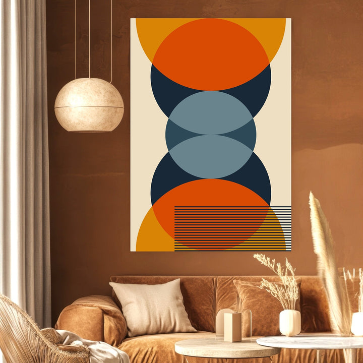Wadi Home mid-century modern geometric wall art with orange, navy, and slate blue circles in a warm-toned living room.