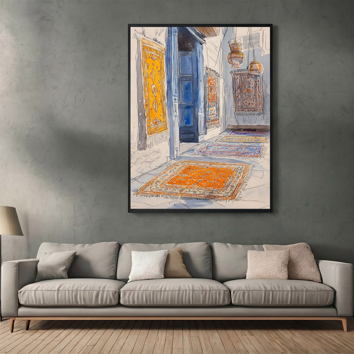 Wadi Home watercolor wall art print of a Middle Eastern bazaar with hanging rugs and blue doors above a grey sofa.