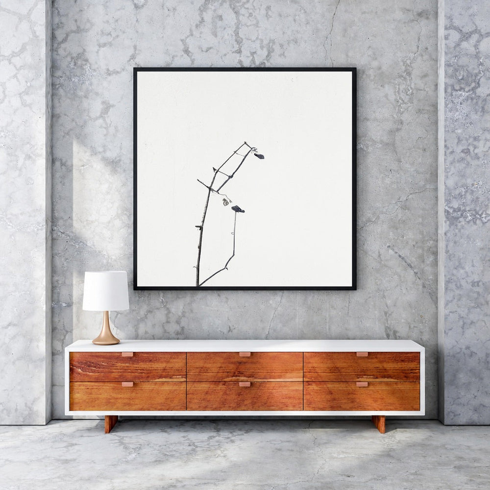 Wadi Home framed minimalist art print of delicate black branches against a white background, with a black MDF frame.