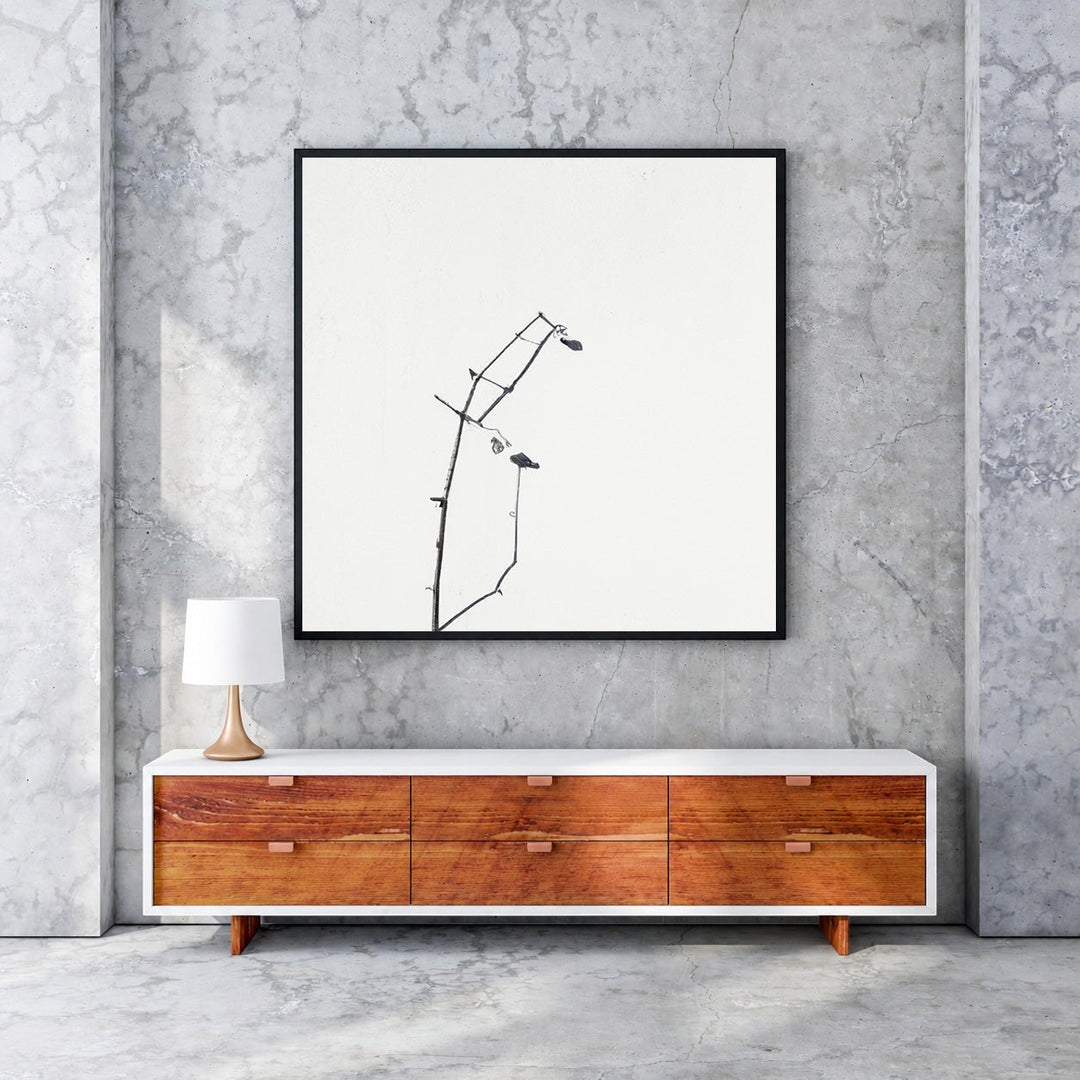 Wadi Home framed minimalist art print of delicate black branches against a white background, with a black MDF frame.