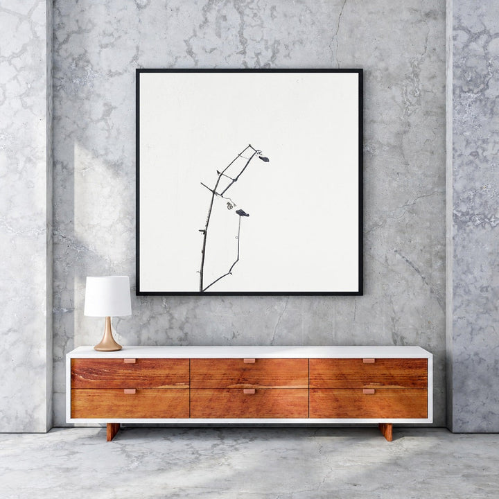 Wadi Home framed minimalist art print of delicate black branches against a white background, with a black MDF frame.