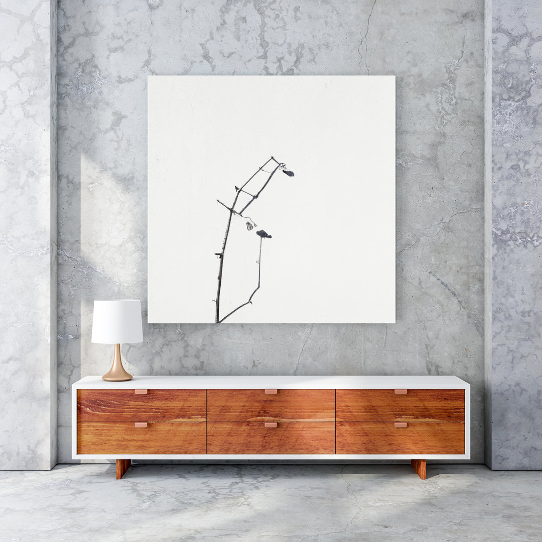 Wadi Home minimalist framed art print of a delicate black branch with small buds against a white background.
