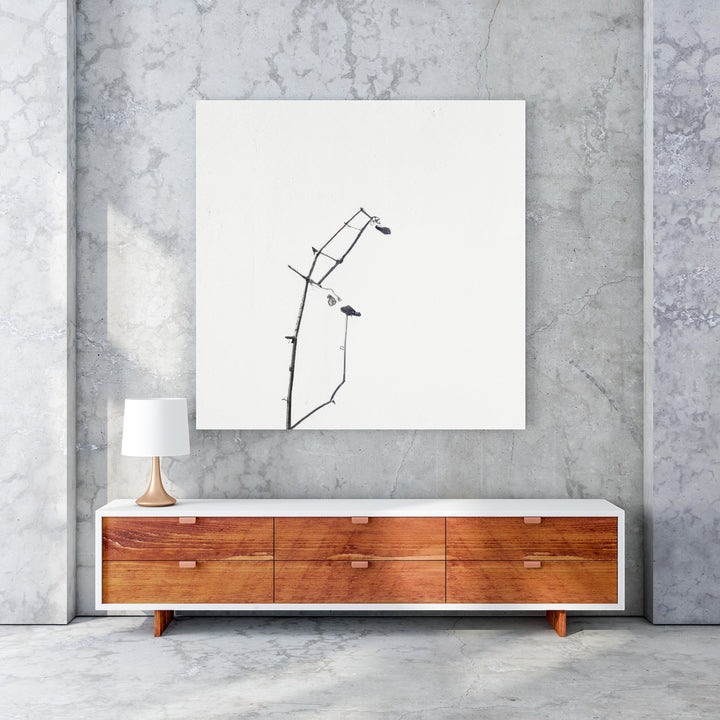 Wadi Home minimalist framed art print of a delicate black branch with small buds against a white background.