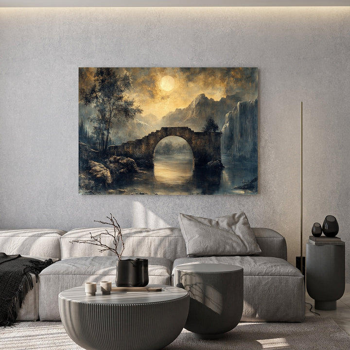 Wadi Home moonlit stone bridge landscape wall art print hanging above a modern grey sofa in a minimalist living room.