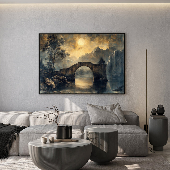 Wadi Home moonlit stone bridge landscape wall art print hanging above a modern grey sofa in a minimalist living room.