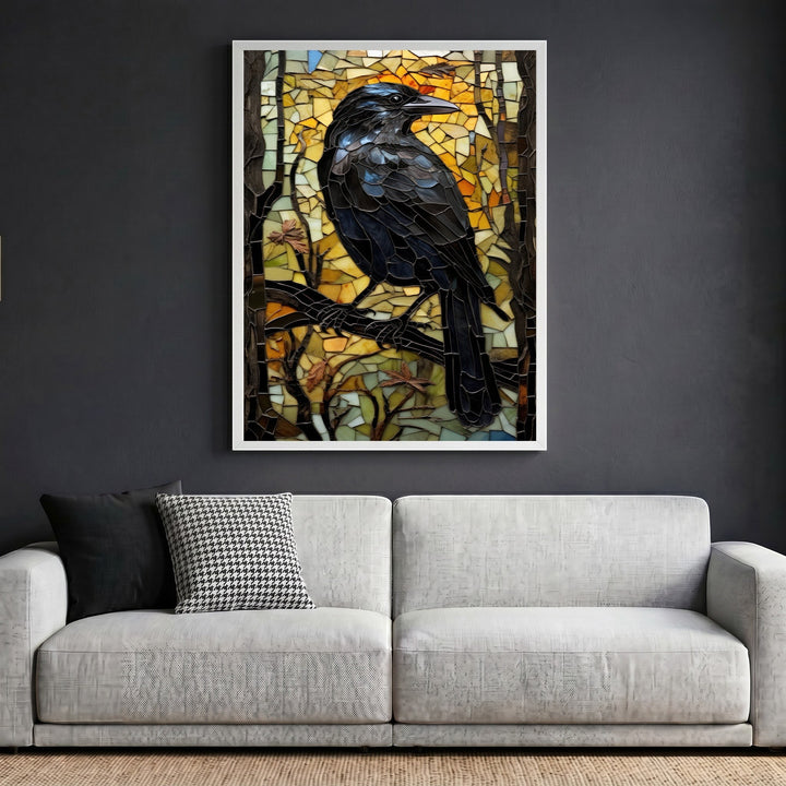 Wadi Home mosaic raven wall art in a white frame hanging above a modern grey sofa in a living room setting.