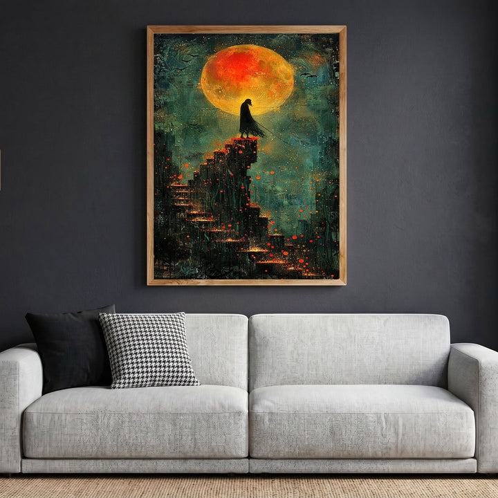 Wadi Home framed wall art featuring a cloaked figure on stairs under a large blood-orange moon in teal and charcoal.