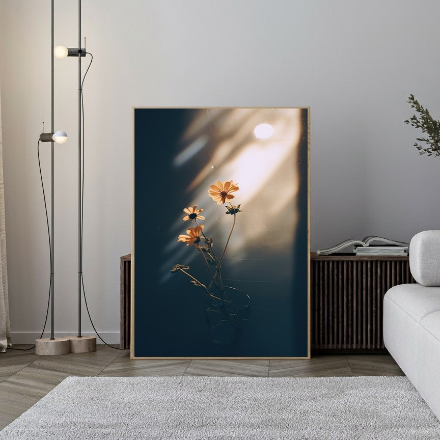 Wadi Home framed print of delicate orange flowers in a glass vase, bathed in warm sunlight with dramatic shadows.